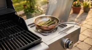 Graphic showing food capacity layout on a small gas grill cooking surface with four burger patties and two corn cobs.