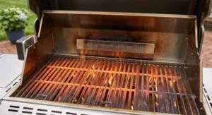 Preheated porcelain-enameled cast iron grates on a open-lid 6 burner gas grill showing searing heat distribution.